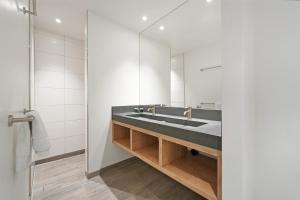 a bathroom with a sink and a mirror at Villa Super VIP | 4 pers. (Villa 68) in Ouddorp +35 photos