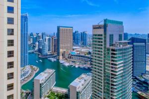a view of a city with a river and buildings at Luxurious Brand New 2BR Apartment in Rimal 1 I Steps to the JBR Beach I GYL Holiday Homes in Dubai