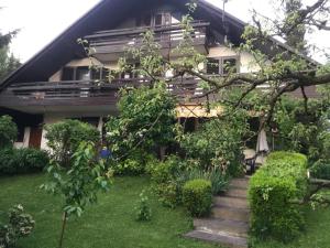 a house with stairs in front of it at Vila Nana Bled Apartments & Rooms in Bled