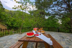 a wooden picnic table with a sliced watermelon on it at Amazing Villa in Pano Platres Cyprus in Kato Platres