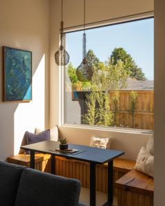 a living room with a table and a large window at Blackheath Bivy in Blackheath +19 photos