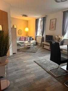 a living room with a couch and a table at SanMar 1 Ferien und Wohnpark Residenz in Meisdorf
