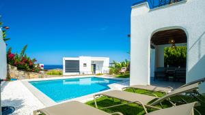 a villa with a swimming pool and the ocean at Villa Greta in Bodrum City