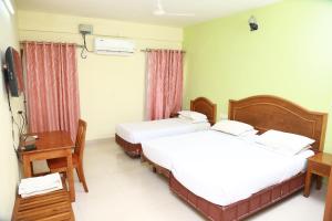 KTDC Tamarind Guruvayoor - Aahaar Guruvayoor客房内的一张或多张床位