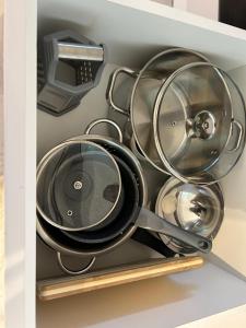 a drawer filled with pots and pans at Best Value Studio Primavara, Free Parking in Bucharest +12 photos