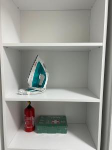 a white book shelf with a computer on it at Best Value Studio Primavara, Free Parking in Bucharest