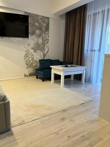 a living room with a blue couch and a table at Best Value Studio Primavara, Free Parking in Bucharest