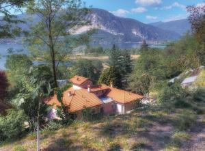 a house on a hill with a view of a lake at Villetta La Foresteria in Verbania