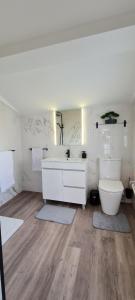 a white bathroom with a toilet and a sink at Casa Miramar in Algarvia +44 photos