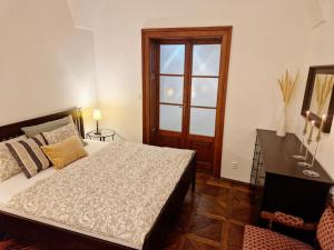 a bedroom with a bed and a desk and a window at Marina Old Town Apartment with 1 free parking offsite in Košice