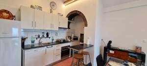 a kitchen with white cabinets and a white refrigerator at Casa Miramar in Algarvia