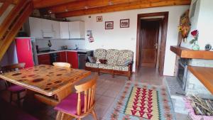 a kitchen with a table and a dining room at Castoro holiday in Torgnon