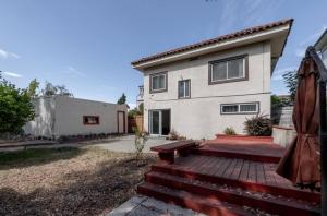 a house with a wooden deck in front of it at Affordable Dorm Hayward in Hayward