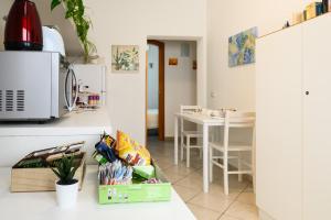 a kitchen and dining room with a table and a counter at Girasole room Sperlongaresort in Sperlonga