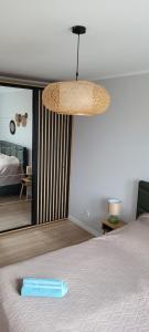 a bedroom with a bed with a blue pillow on it at NATURA apartament in Malbork