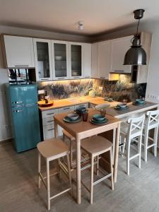 a kitchen with a table and a blue refrigerator at Apartment Nona Celina in Zadar