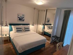 a bedroom with a large bed and a mirror at Apartment Nona Celina in Zadar
