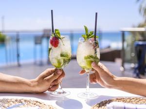 two people holding up two wine glasses with fruit and vegetables at Villa Almendro Santa Rosalia Lake and Life Resort by PREMIUM SPAIN PROPERTIES in Torre-Pacheco