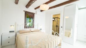 a white bedroom with a white bed and a window at Villa Greta in Bodrum City +16 photos