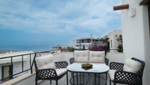 a patio with a table and chairs on a balcony at Villa Greta in Bodrum City