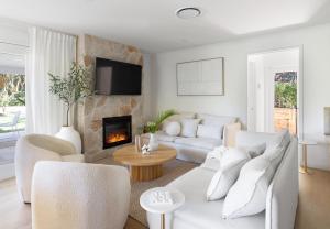 a living room with white furniture and a fireplace at Luxury Montville getaway for up to 12 guests in Montville
