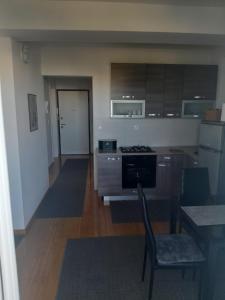 a kitchen with a table and a chair in a room at Apartman Novalja - Put Lokvice in Novalja