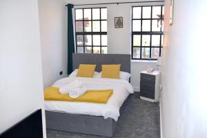 a bedroom with a bed and two windows at Modern home in Birmingham in Birmingham