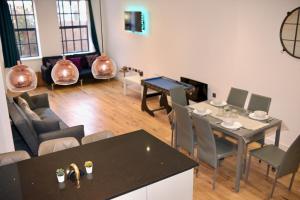 a living room with a table and chairs at Modern home in Birmingham in Birmingham