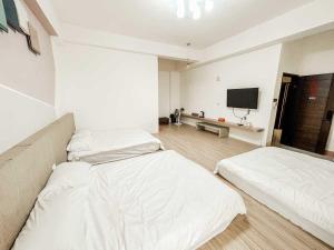 Uma cama ou camas num quarto em 澎湖樂在綺中民宿 第580號