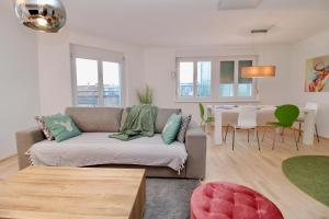 a living room with a couch and a table at Graz central Penthouse Style Apt in Graz