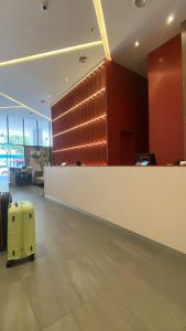 a yellow suitcase is sitting in an airport lobby at HS HOMESTAY The Shore near SAFMA - Pasar Besar in Kota Kinabalu +30 photos