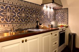 a kitchen with a sink and a counter at Stone City Hostel in Gjirokastër