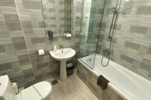 a bathroom with a sink and a toilet and a shower at Miraj Apartaments - Exclusive Residence in Mamaia +37 photos