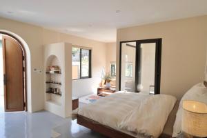a bedroom with a large bed and a large window at Panacea The Villa in Mộc Châu