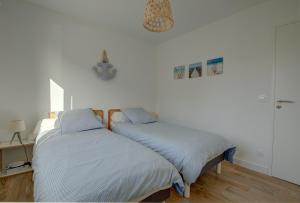 Postel nebo postele na pokoji v ubytování Maison de l'Aiguillon