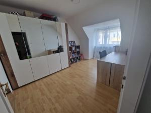 a living room with a large white cabinet and a desk at Wunderschöne & Moderne 60m2 Wohnung in Judenburg