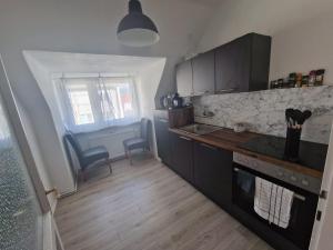 a kitchen with a sink and a counter top at Wunderschöne & Moderne 60m2 Wohnung in Judenburg +6 photos