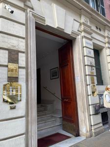 an entrance to a building with a wooden door at YouRoominRome in Rome