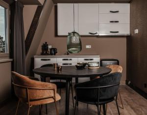 a kitchen with a table and chairs in a room at Boutique Hotel Noordeinde in Rijnsburg