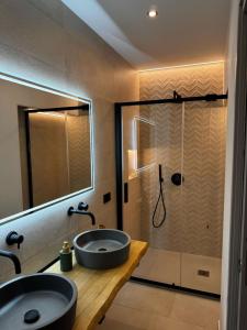 a bathroom with a sink and a shower at Sardinian Days - Suites & Rooms in Cagliari