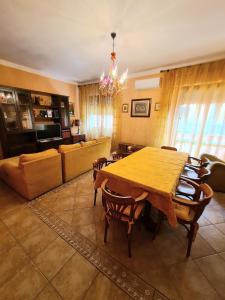 a living room with a wooden table and chairs at Casa vacanze zona mare in Quartu SantʼElena +7 photos