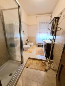 a bathroom with a shower and a sink and a toilet at Casa vacanze zona mare in Quartu SantʼElena