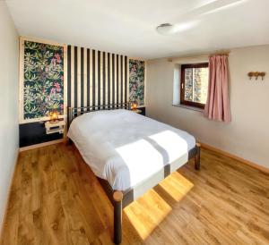 a bedroom with a large bed in a room at Welcoming house in Stavelot with sauna and garden in Francheville