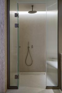 a shower with a glass door in a bathroom at Princess Resort, Santikos Collection in Agia Paraskevi