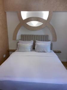 a large white bed with white pillows in a bedroom at CC Luxurious Apartment in Hurghada +39 photos