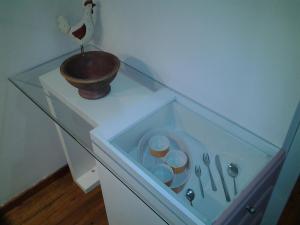 a glass table with a bowl and utensils on it at Mastic Point Studios in Chios
