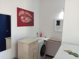 a bathroom with a sink and a washing machine at Canova Apartment in Santa Maria