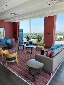a lobby with couches and tables and windows at Hampton By Hilton Valledupar in Valledupar