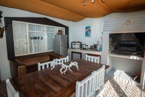 a kitchen with a wooden table and a dining room at Le Franz in Parys