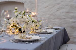 a table with plates and wine glasses and flowers at Teleki-Wattay Kastélyszálló in Pomáz